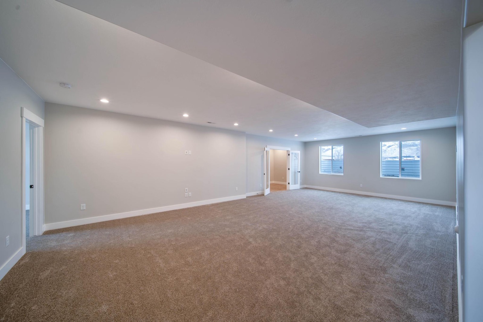Basement apartment living space with recessed lighting and luxury vinyl plank flooring