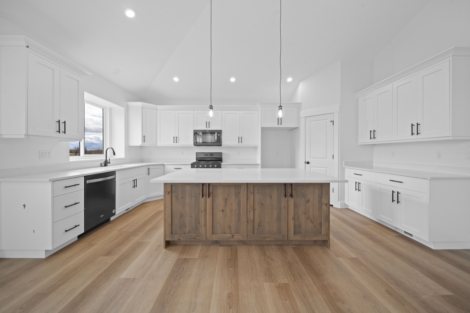 Remodeled kitchen with a tile backsplash and new appliances